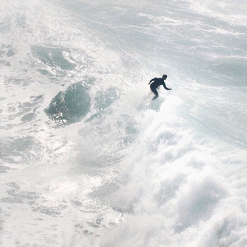 Surfer riding wave by Rosie Bondi